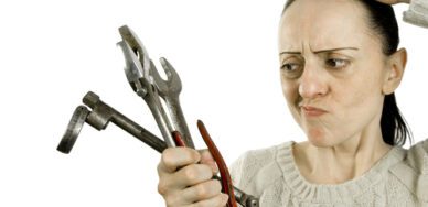 confused look while holding tools