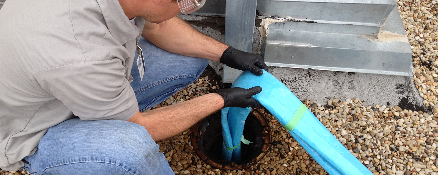 commercial-trenchless-3 Epoxy liner being fed down a damaged pipe by Accurate Leak & Line.