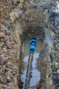 broken pvc pipe in trench leaks water